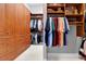 Spacious walk-in closet with custom wood shelving and storage for clothing and accessories at 5016 Givendale Ln, Tampa, FL 33647