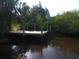 Wooden dock on calm waterway with lush vegetation at 6109 Adams St, Gibsonton, FL 33534