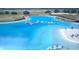 Aerial view of Crystal Lagoon amenity with expansive beach and watersports at 32088 Powderpuff Mimosa Dr, San Antonio, FL 33576
