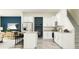 Modern kitchen with white cabinets, granite countertops and an island at 32088 Powderpuff Mimosa Dr, San Antonio, FL 33576