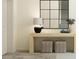 Light and airy entryway with console table, mirror, and stylish ottomans at 32088 Powderpuff Mimosa Dr, San Antonio, FL 33576