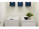 Laundry room with washer, dryer, and overhead shelving for storage at 32088 Powderpuff Mimosa Dr, San Antonio, FL 33576