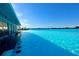 Expansive Crystal Lagoon with a swim-up bar and lounge area at 32088 Powderpuff Mimosa Dr, San Antonio, FL 33576