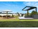 Landscaped backyard with modern patio furniture and pergola at 839 Tierra Dr, Spring Hill, FL 34609