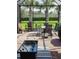 Screened patio with seating area and fire pit at 12831 Oriago St, Venice, FL 34293