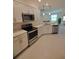 Modern kitchen with stainless steel appliances and white cabinets at 12831 Oriago St, Venice, FL 34293