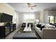 Relaxing living room with comfortable seating and a large flat-screen TV at 32112 Powderpuff Mimosa Dr, San Antonio, FL 33576