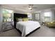 Main bedroom with a black velvet headboard and green accents at 32112 Powderpuff Mimosa Dr, San Antonio, FL 33576