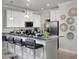 Modern kitchen with white cabinets, granite countertops, and breakfast bar at 32112 Powderpuff Mimosa Dr, San Antonio, FL 33576