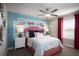 Charming bedroom with a coral headboard and a whimsical wall decal at 32112 Powderpuff Mimosa Dr, San Antonio, FL 33576