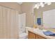 Bathroom with a single sink and vanity and a shower-tub combo with curtain at 8049 Sanguinelli Rd, Land O Lakes, FL 34637