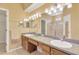 Bathroom boasts a dual vanity, framed mirrors, with tile flooring and plenty of counter space at 8049 Sanguinelli Rd, Land O Lakes, FL 34637