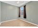 This bedroom features vinyl floors, gray walls and a window at 8049 Sanguinelli Rd, Land O Lakes, FL 34637