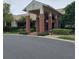 Community clubhouse featuring a welcoming entrance, brick columns, and well-maintained landscaping at 8049 Sanguinelli Rd, Land O Lakes, FL 34637