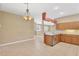 Bright kitchen featuring tile floors, tan cabinetry, and marble countertops at 8049 Sanguinelli Rd, Land O Lakes, FL 34637