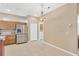 Bright kitchen with stainless steel refrigerator, ample cabinet space, and tile flooring at 8049 Sanguinelli Rd, Land O Lakes, FL 34637