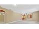 Large open living space with neutral color palette, track lighting, and seamless flow to other rooms at 8049 Sanguinelli Rd, Land O Lakes, FL 34637
