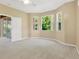 Spacious main bedroom with three windows, ceiling fan and sliding glass door to screened lanai at 8049 Sanguinelli Rd, Land O Lakes, FL 34637