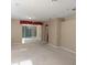Living room with sliding glass doors and backyard access at 8049 Sanguinelli Rd, Land O Lakes, FL 34637