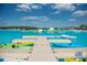 Large lagoon pool with kayaks and inflatable obstacles at 10368 Honey Hammock Way, San Antonio, FL 33576