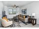 Spacious living room with a neutral color palette and large windows at 10368 Honey Hammock Way, San Antonio, FL 33576