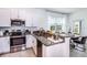 Modern kitchen with stainless steel appliances and granite countertops at 10368 Honey Hammock Way, San Antonio, FL 33576