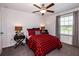 Cozy bedroom with red and black plaid bedding and window coverings at 10368 Honey Hammock Way, San Antonio, FL 33576