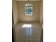 Empty bedroom with tiled floors and a window at 303 E Wellington Ct # 59, Tampa, FL 33604