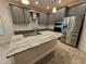 Modern kitchen with gray cabinets, granite countertops and stainless steel appliances at 16320 Hyde Manor Dr, Tampa, FL 33647