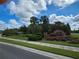 Landscaped entrance to Stafford Place with a brick sign and palm trees at 16320 Hyde Manor Dr, Tampa, FL 33647