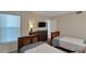 Guest bedroom with twin beds and access to a shared bathroom at 17980 Gulf Blvd # 205, Redington Shores, FL 33708
