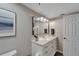 Clean bathroom with white vanity, marble countertop and a large mirror at 17980 Gulf Blvd # 205, Redington Shores, FL 33708