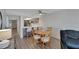 Bright dining area with wood table and chairs, adjacent to kitchen at 17980 Gulf Blvd # 205, Redington Shores, FL 33708