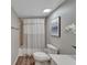 Clean bathroom with shower/tub combo, toilet and updated vanity at 17980 Gulf Blvd # 205, Redington Shores, FL 33708