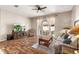 Living area features hardwood floors, sliding glass doors and a large TV at 3001 Silvermill Loop, Land O Lakes, FL 34638
