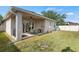 Covered patio and spacious grassy backyard at 3001 Silvermill Loop, Land O Lakes, FL 34638