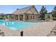 Community pool with adjacent clubhouse at 3001 Silvermill Loop, Land O Lakes, FL 34638