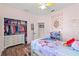Well-lit bedroom with a twin bed, built-in shelving, and closet at 3001 Silvermill Loop, Land O Lakes, FL 34638