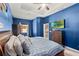 Spacious main bedroom with blue walls and en-suite bathroom access at 3001 Silvermill Loop, Land O Lakes, FL 34638