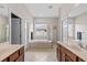 Main bathroom with double sinks, a soaking tub, and a shower at 3001 Silvermill Loop, Land O Lakes, FL 34638