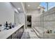 Luxurious bathroom with marble finishes, a soaking tub, and separate shower at 10301 Manta Way, Tampa, FL 33615