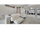Open living area featuring a white sectional sofa and access to backyard at 10301 Manta Way, Tampa, FL 33615