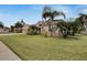 House with three car garage, palm trees, and well-maintained lawn at 10301 Manta Way, Tampa, FL 33615