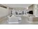 Open living room with white sectional sofa and built-in entertainment center at 10301 Manta Way, Tampa, FL 33615
