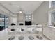 Open kitchen with breakfast bar, white cabinets, and a fireplace at 10301 Manta Way, Tampa, FL 33615