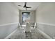 Elegant dining room with a glass table and four white chairs at 10301 Manta Way, Tampa, FL 33615