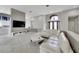 Bright and airy living room with a large sectional sofa and entryway view at 10301 Manta Way, Tampa, FL 33615