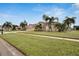 House with three car garage, side yard view, and palm trees at 10301 Manta Way, Tampa, FL 33615