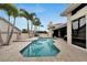 Inviting kidney-shaped pool surrounded by a spacious paved patio at 10301 Manta Way, Tampa, FL 33615