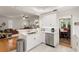 Bright kitchen with white cabinets, stainless steel appliances, and an open view to the living and dining areas at 2839 Bayshore Trails Dr, Tampa, FL 33611